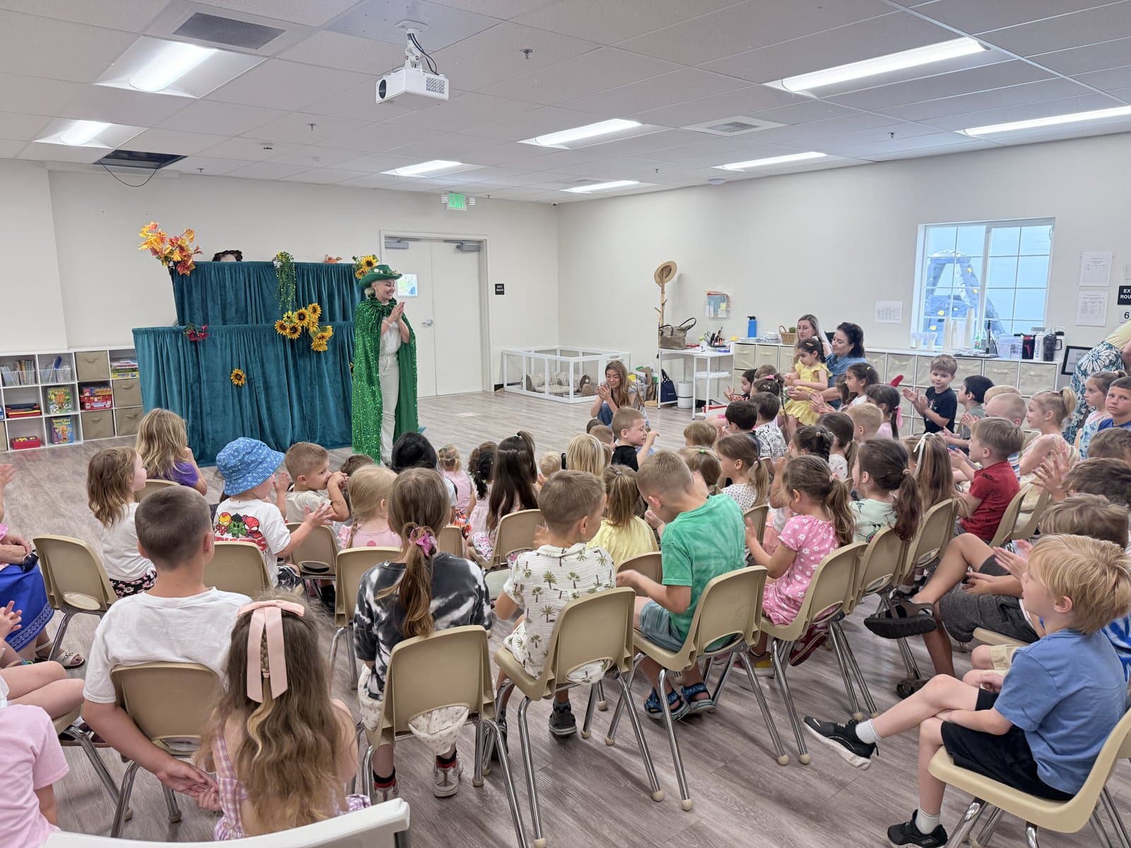 A live costumed show for a room full of seated preschoolers in their classroom.